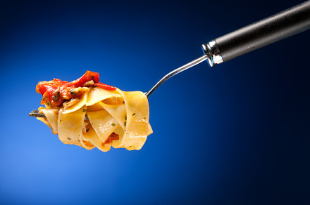 Tagliatelle with clams on a red background
