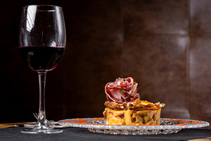 Vertical close up of Spanish potato omelette with Iberian ham and crispy pork r, a Food & Drink Photo by etorres69