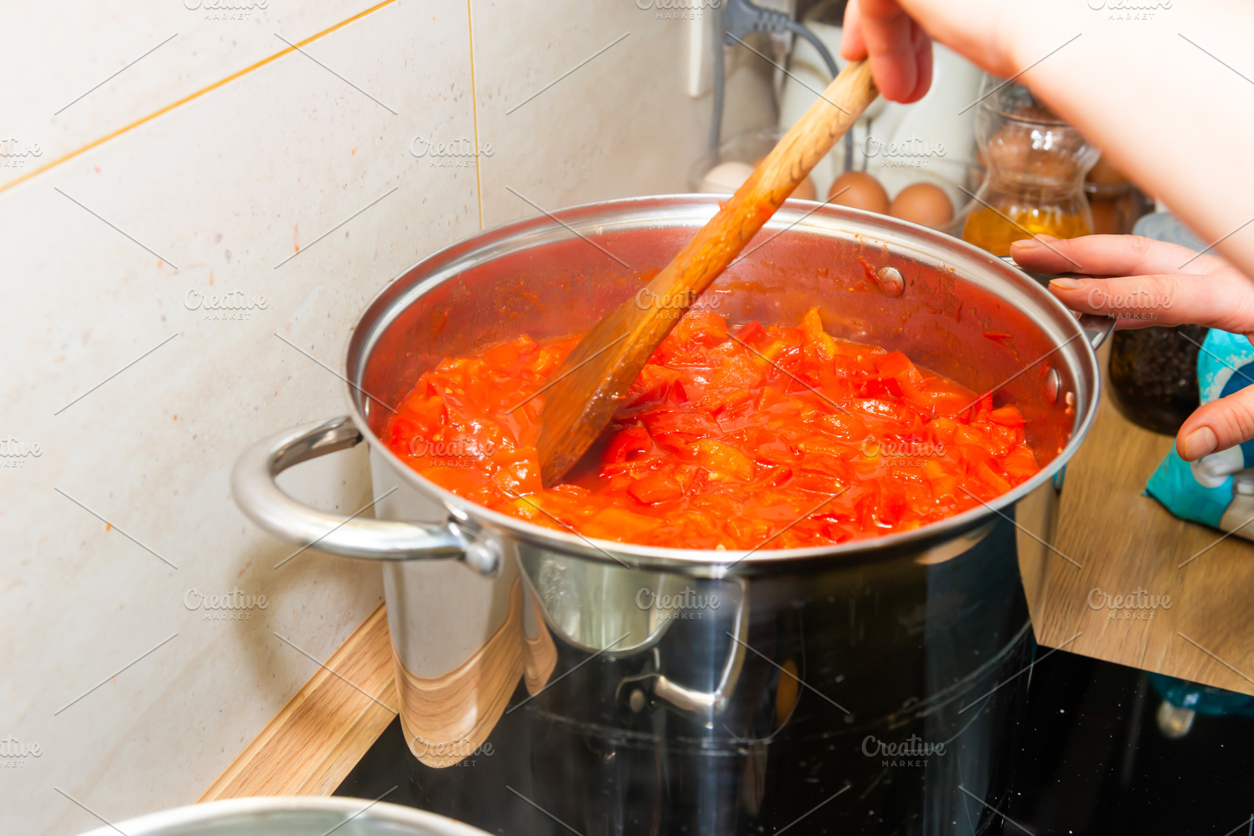 Cooking tomato sauce in big cooking pot, a Food & Drink Photo by Vapi