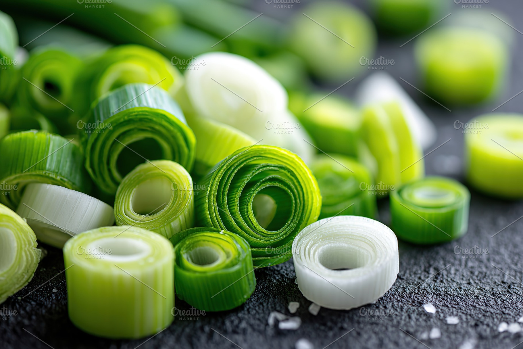 Sliced green onions artfully arranged on a dark surface with salt, showcasing v, a Food & Drink Photo by AlyaAnd