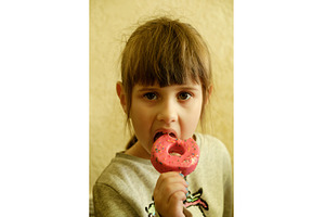 Little girl eating a colorful donut, a Food & Drink Photo by Rohan Photography
