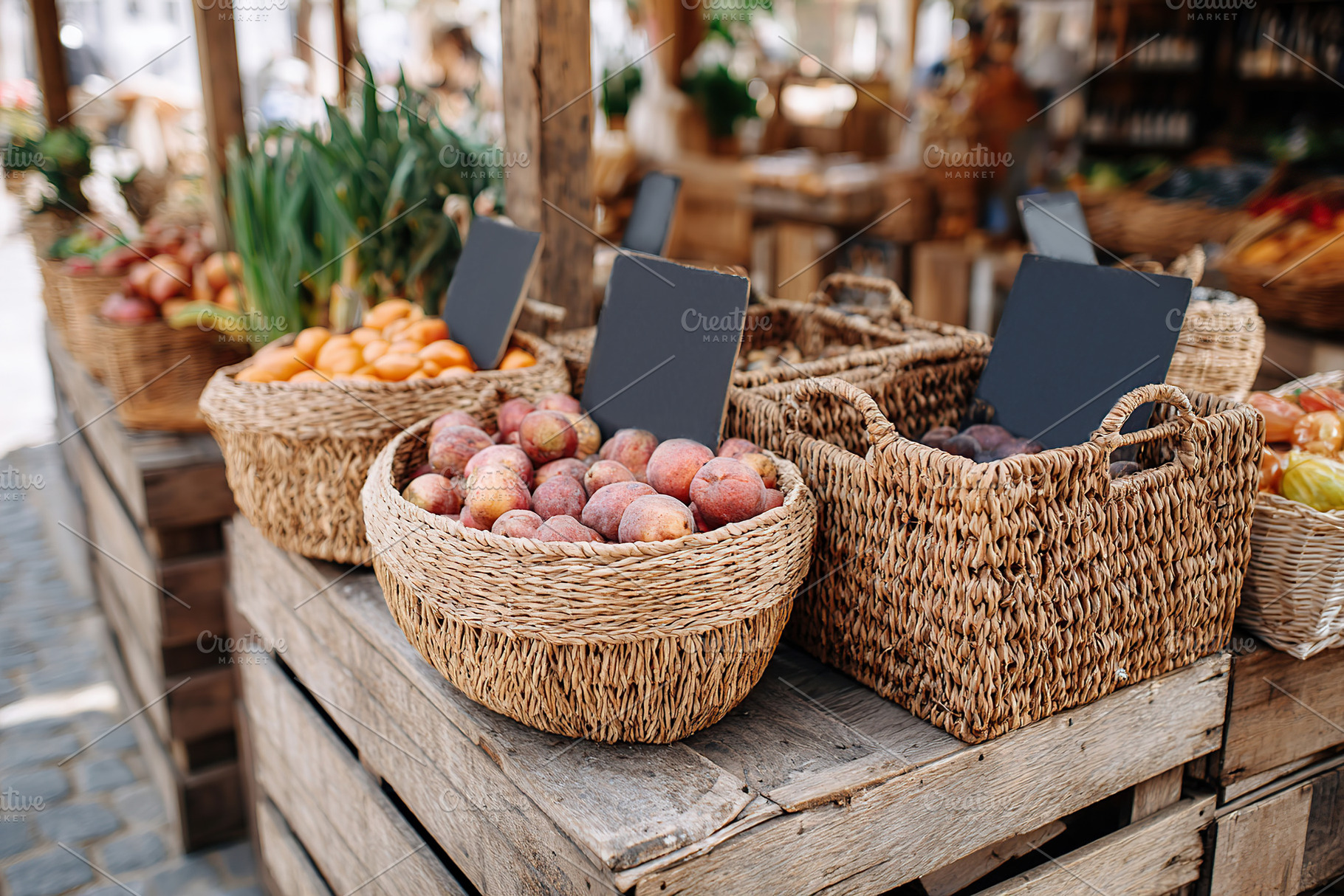 Fresh produce market stand featuring handmade signs and woven baskets of fruits, a Food & Drink Photo by AlyaAnd