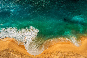 Foamy waves roll over the seashore