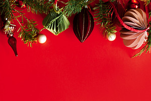 Christmas background with paper ornaments, glass finial, red bau, a Photo by Sonjachni