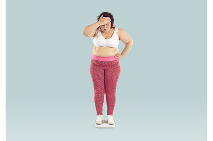 Funny overweight woman weighs