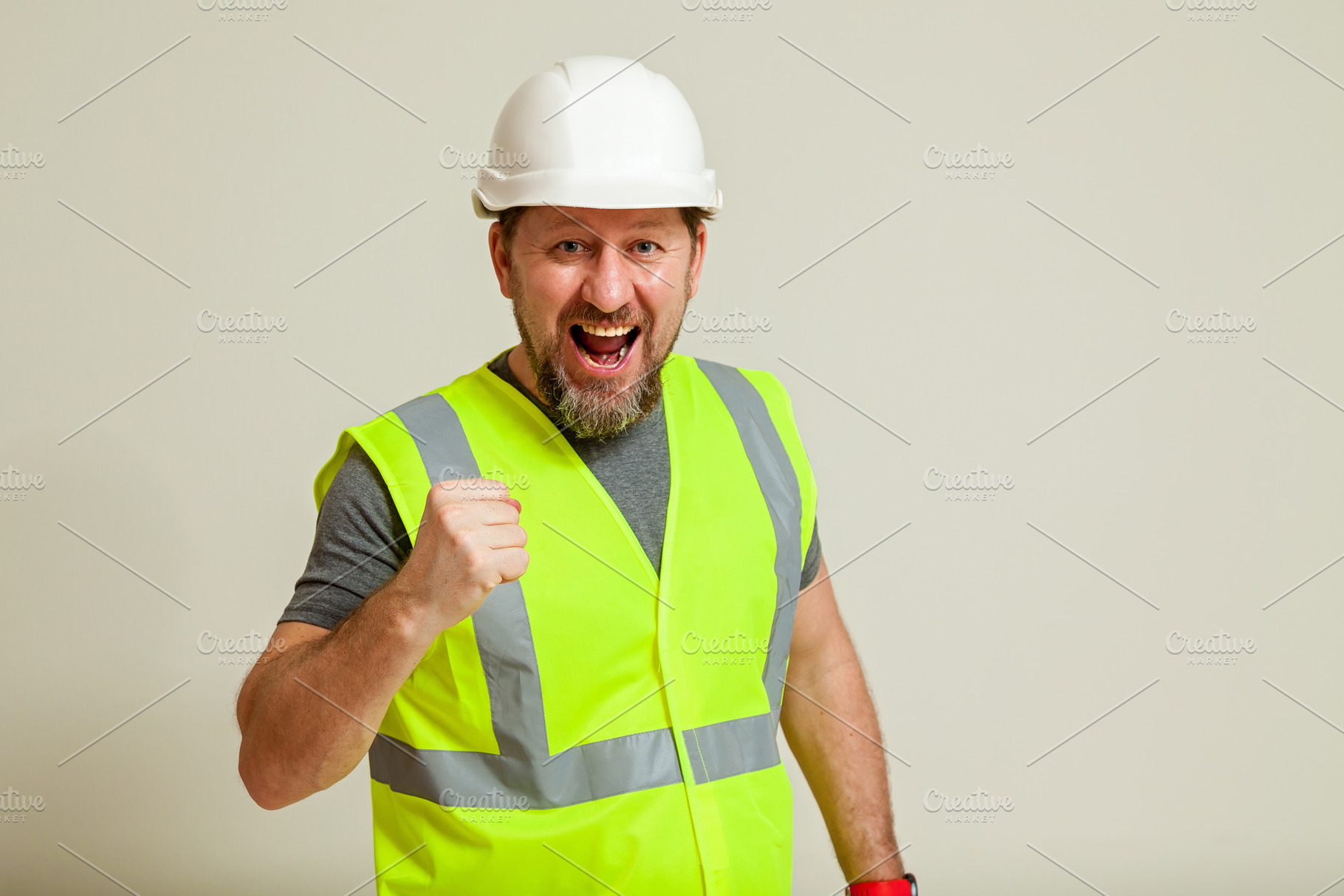 worker in a vest and white helmet, a Person Photo by Photostock