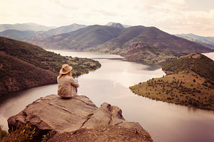 A hiking girl looking at the river containing hiking, girl, and mountain