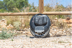 Electric unicycle leaning against, a Technology Photo by Illustrations&photos