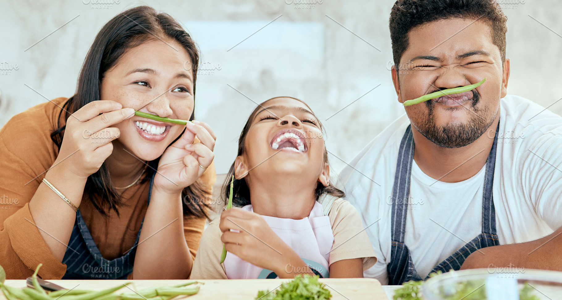 Happy asian family, play vegetables kitchen in portrait and smile together at table for bonding time. Mom dad, child happiness in comic home and health food in nutrition diet, dinner and kid cooking, a Photo by Peopleimages.com