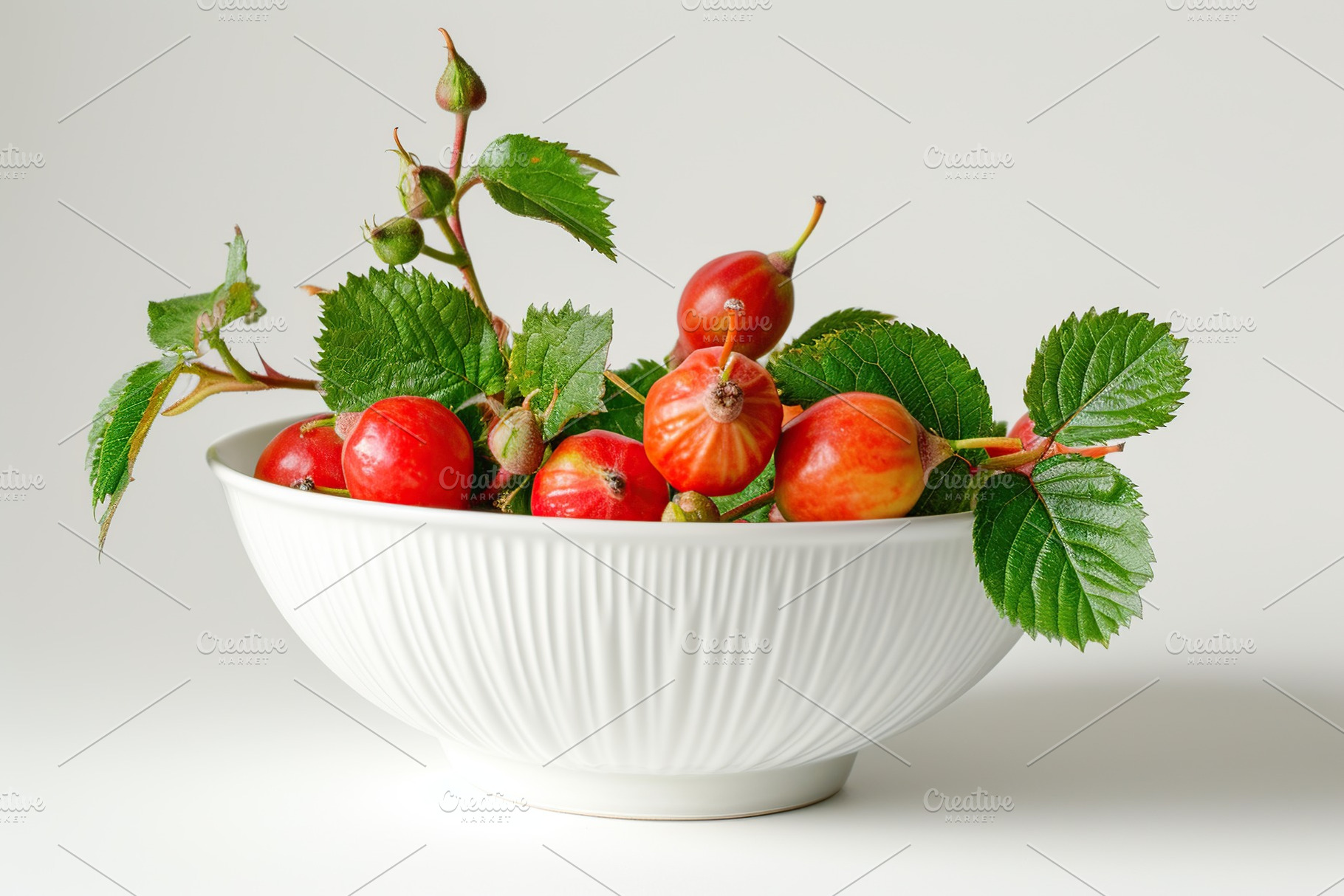 Red rose hip berries in bowl on white background, a Food & Drink Photo by AlyaAnd