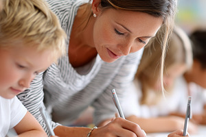 Teacher helping young children with, a School & Education Photo by MistyDay