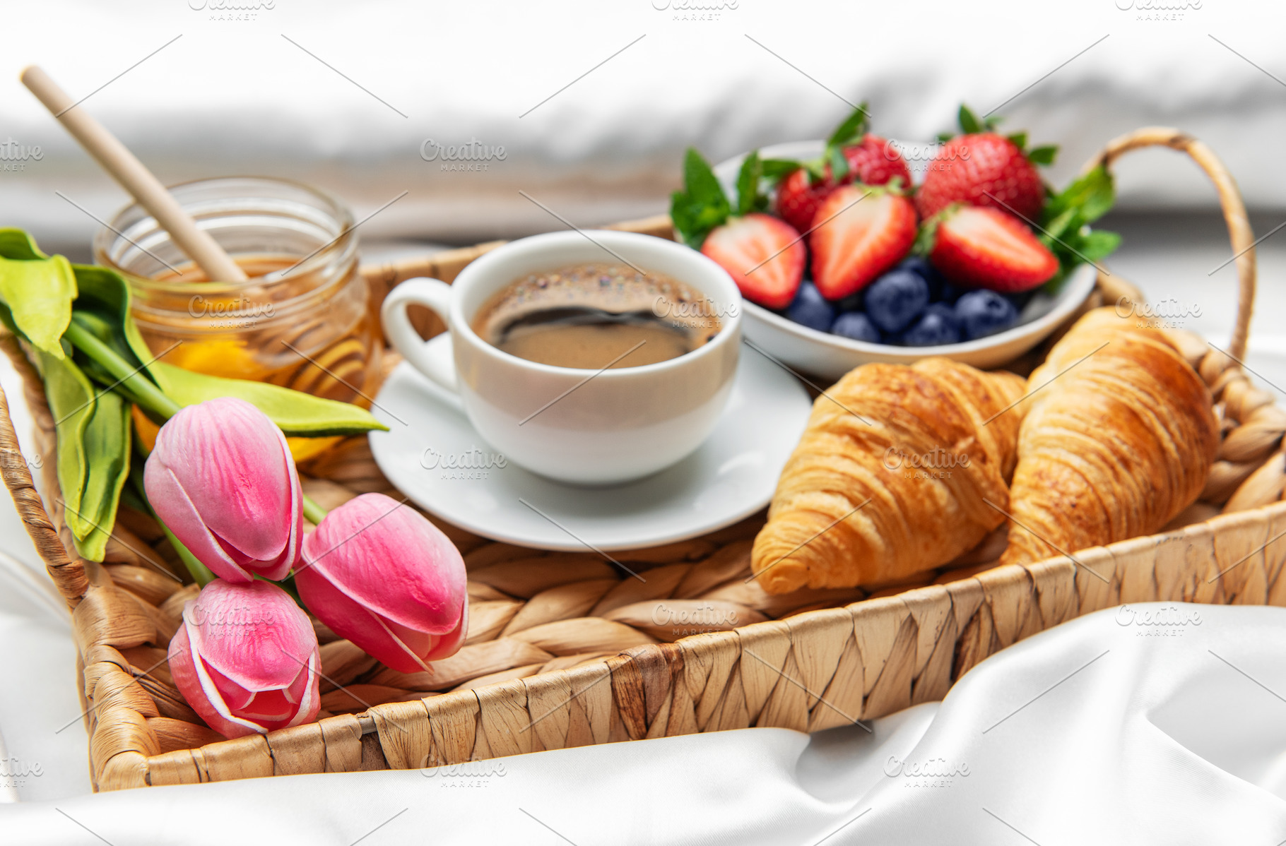 Romantic breakfast in bed with coffee, croissants, berries, hone, a Food & Drink Photo by Olena Rudo