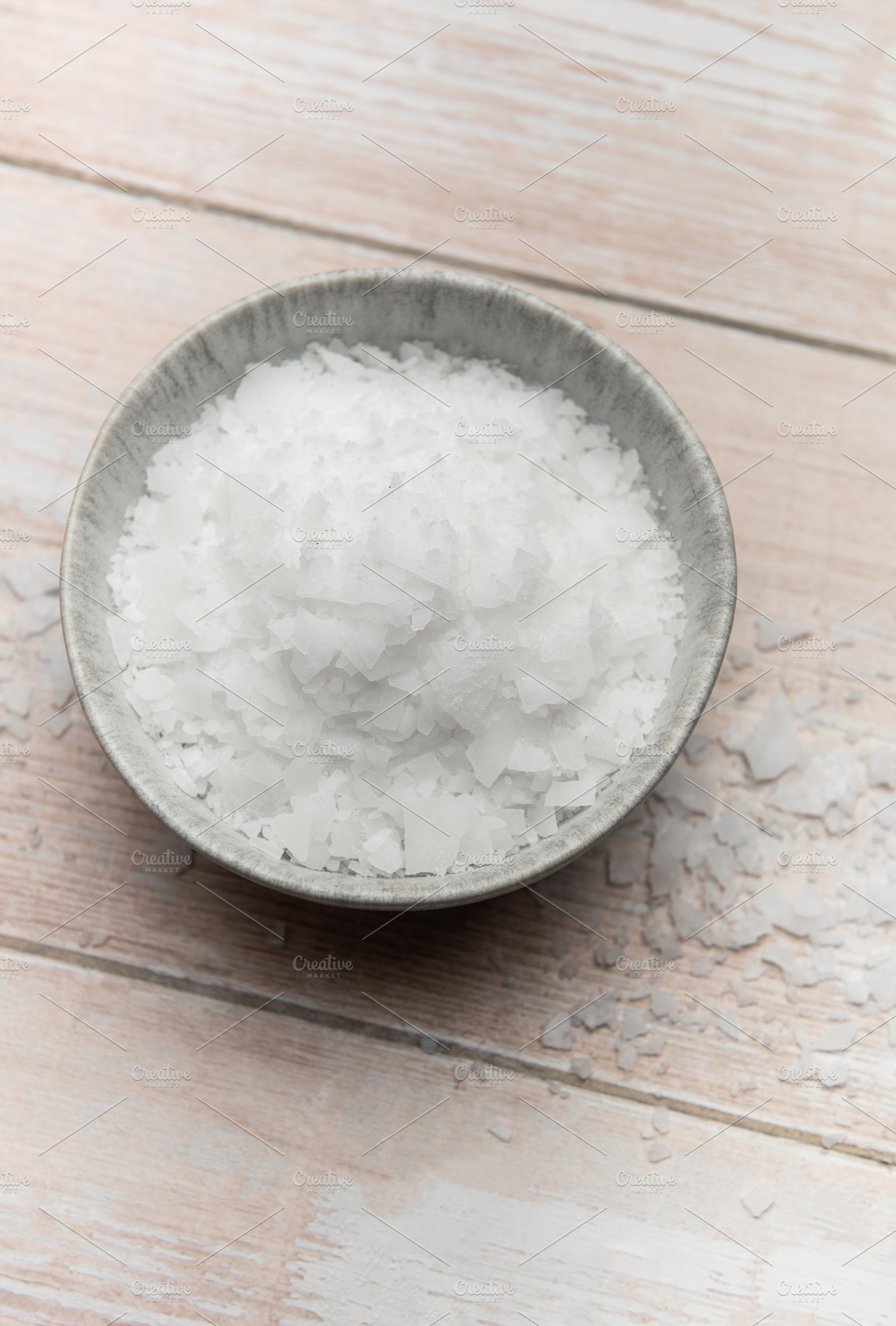 Magnesium flakes in a bowl on wooden table, a Health & Medical Photo by Olena Rudo