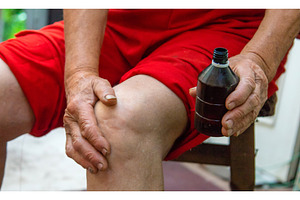 Grandmother treats her knees, smears, a Health & Medical Photo by yanadjana