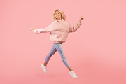 Joyful stylish woman running and jumping, posing in mid-air over pink studio ba, a Photo by Prostock-Studio (Thumbnail 2 of 3)