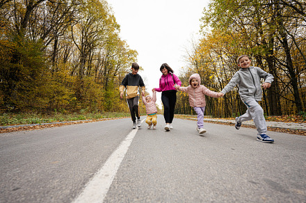 Mother with four kids running on road at autumn fall forest., a Person Photo by AS photostudio