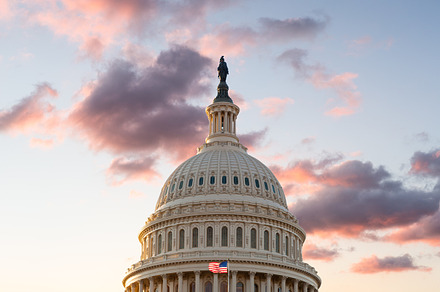 Flag flies in front of Capitol in DC at sunrise, an Architecture Photo by Backyard Stock