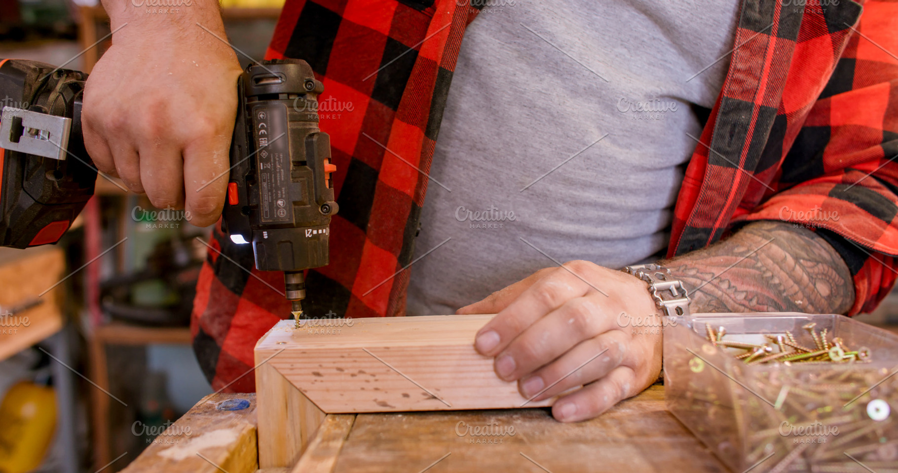 Joiner occupation drilling wood corner joint plank, a Person Photo by Photo Drive Studio