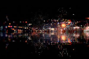 Colorful lights reflect on water, a Photo by Beautiful things