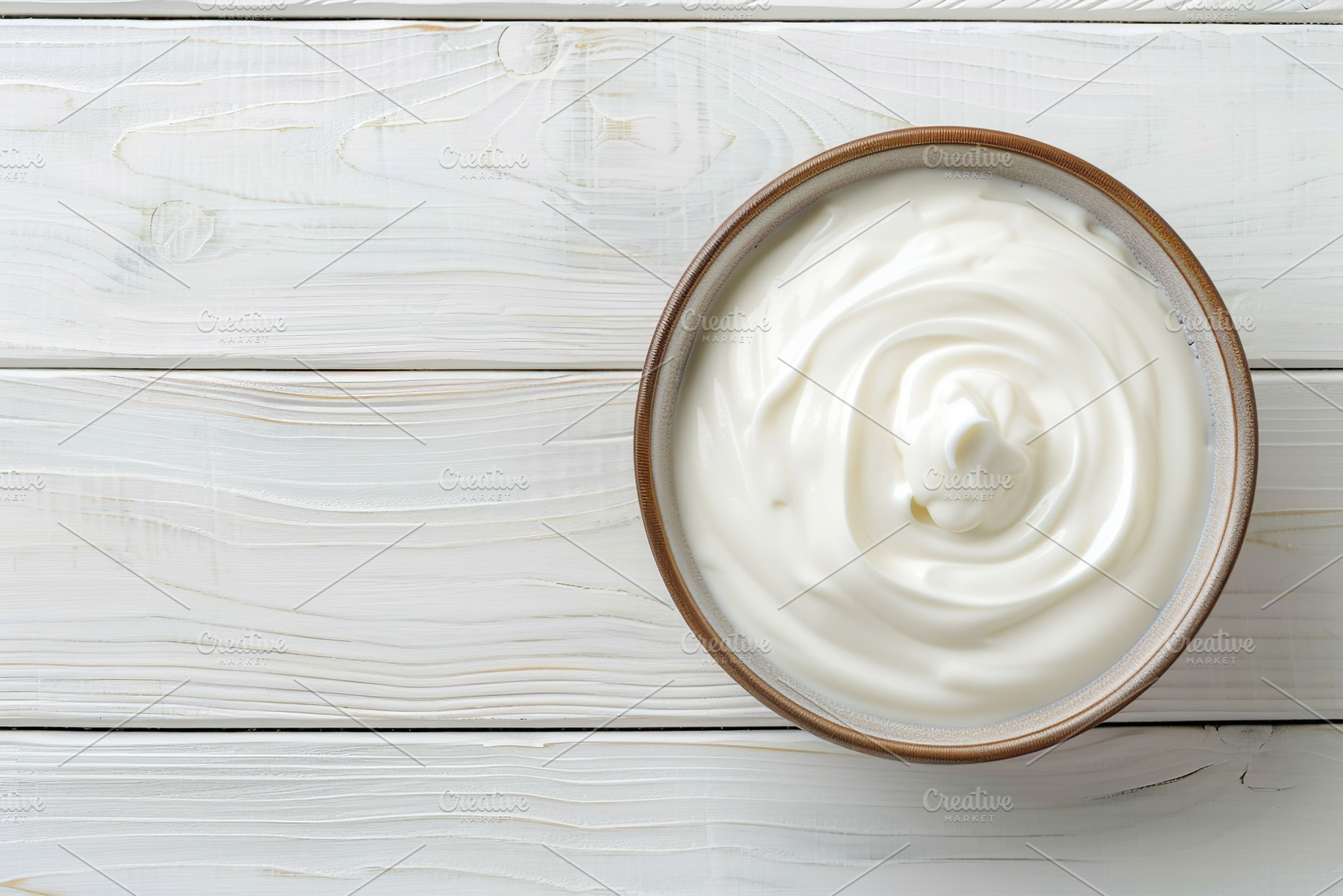 Bowl with white yogurt on wooden table, a Food & Drink Photo by AlyaAnd
