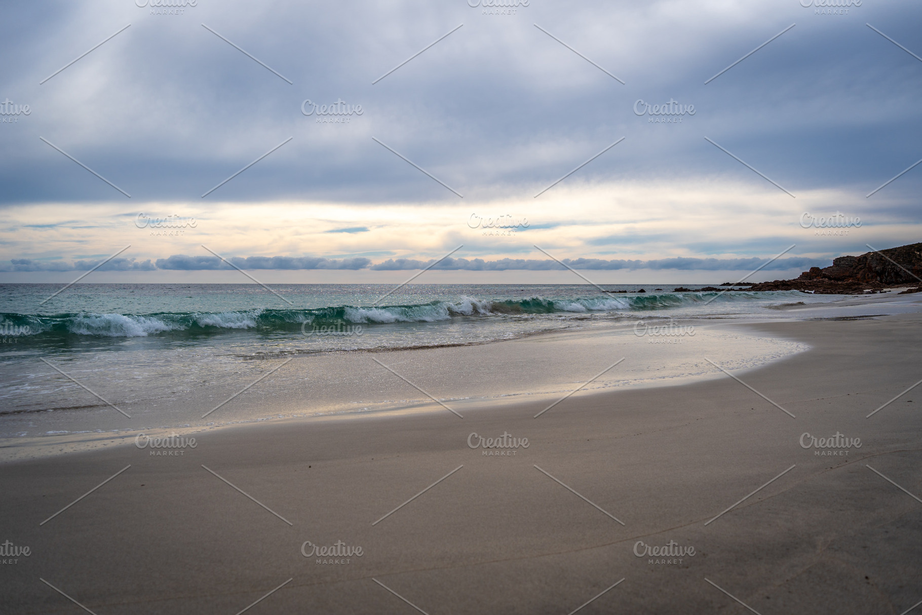 Stokes Bay Beach at sunset with waves and rocks, Australia, a Nature Photo by GoodGoods