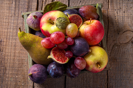 Autumn fruit assortment on wooden background, a Food & Drink Photo by Rimma