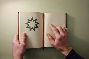 Bahai religious man reading open book on a yellow background, a School & Education Photo by Davizro's Market