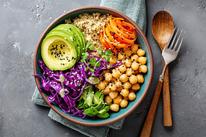 Delicious vegan bowl with quinoa, avocado, and purple cabbage served on a textu, a Food & Drink Photo by AlyaAnd