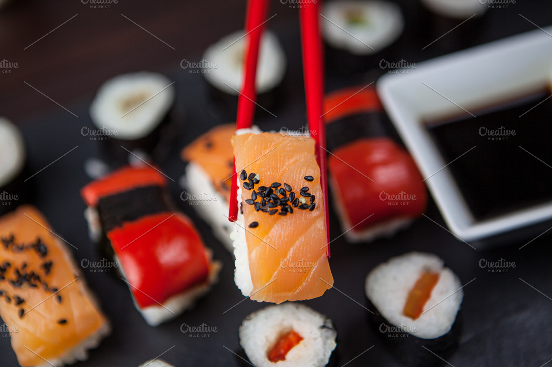 Sushi held in chopsticks, a Food & Drink Photo by Tom Eversley