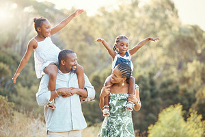Family nature walking park, children and parents happy on walk in garden, communication with smile in summer and comic kids support from mother and father. African man and woman together with girls, a Photo by Peopleimages.com