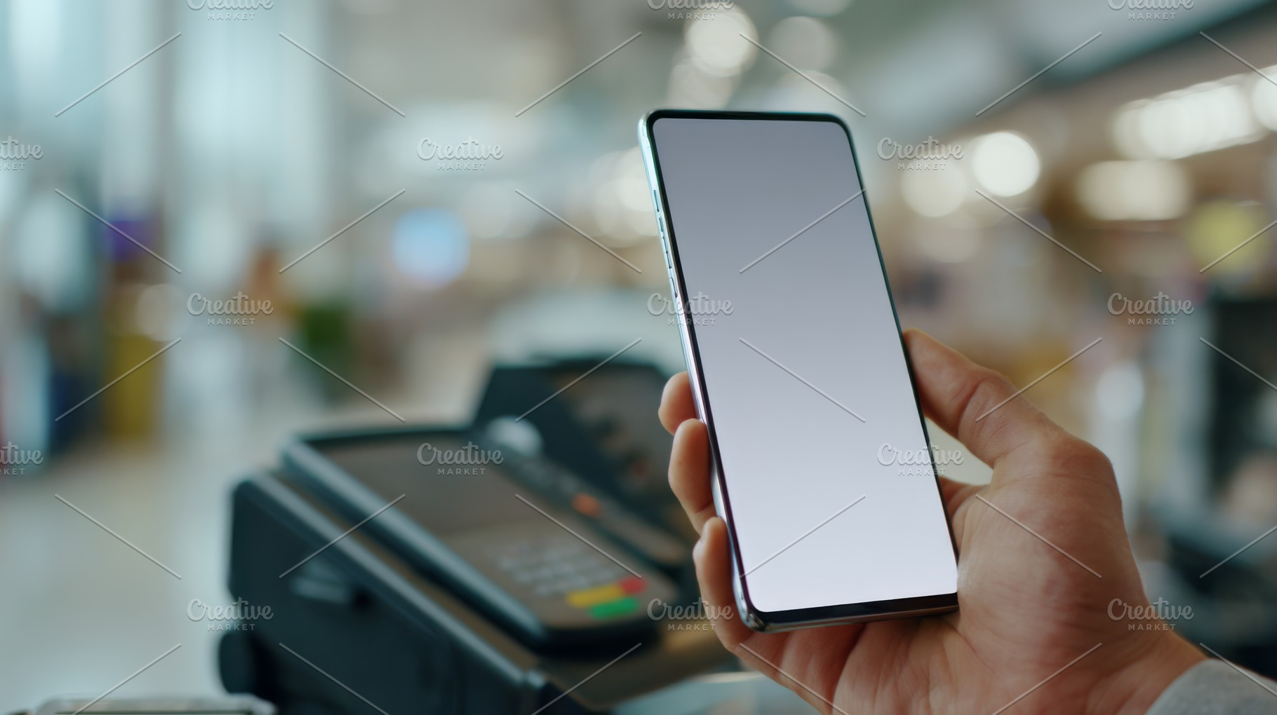 A close-up shot of a hand holding a smartphone with a blank screen, near a paym, a Business Photo by ImageMir