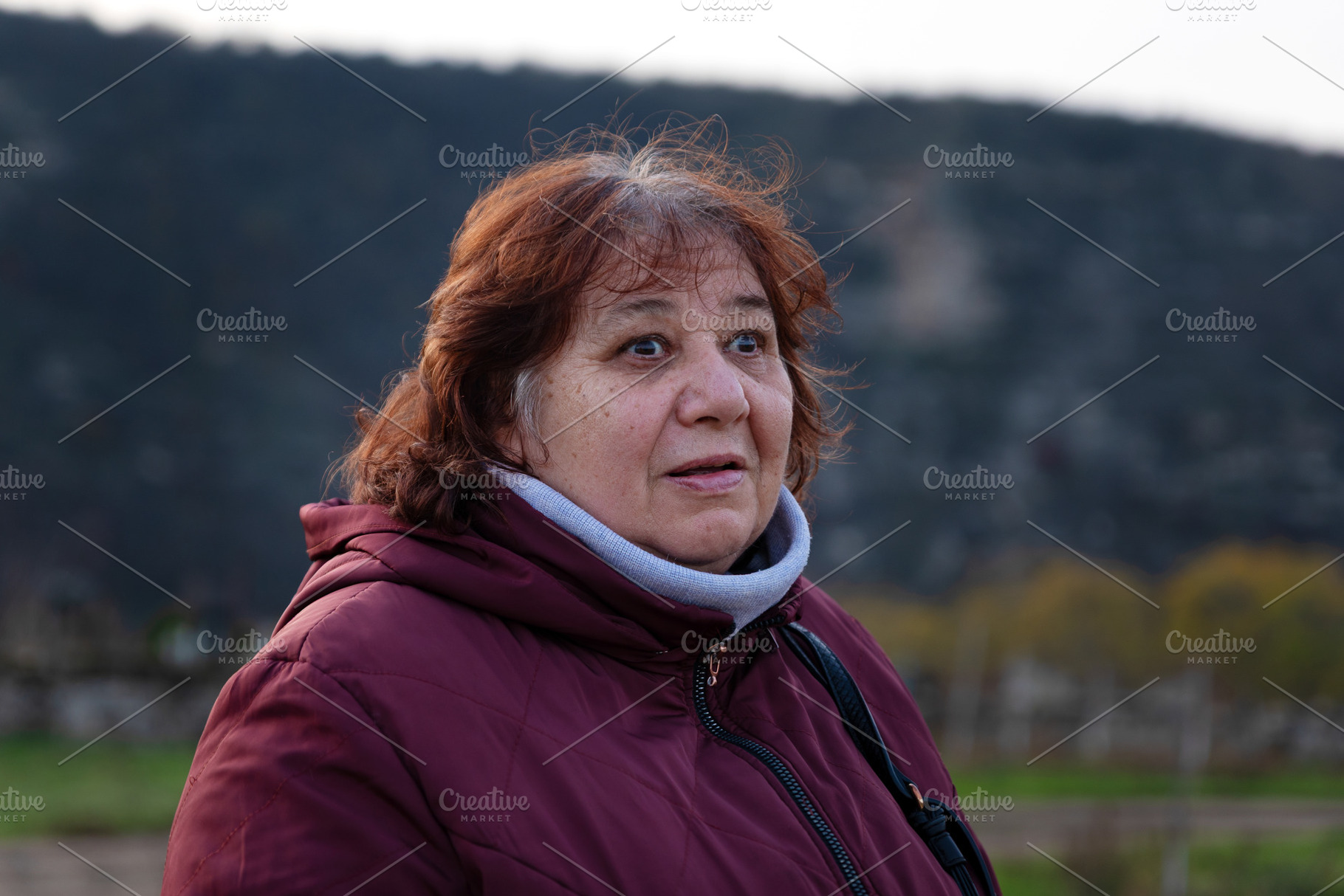 Portrait of a senior woman in a burgundy jacket with an expressi, a Person Photo by Ales Munt