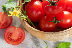 Fresh ripe cherry tomatoes with leaves and flower, a Food & Drink Photo by Olena Rudo