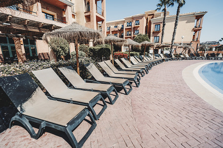 Poolside loungers at sunny resort, a Sports & Recreation Photo by SkyNext