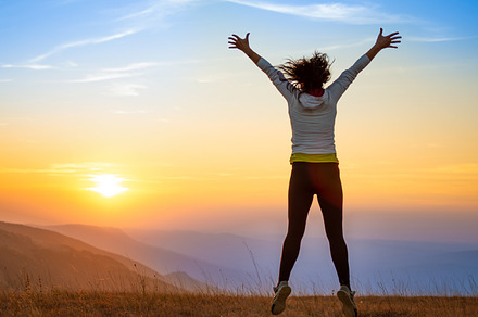 Young woman jumping at sunset mountains, a Person Photo by Vapi