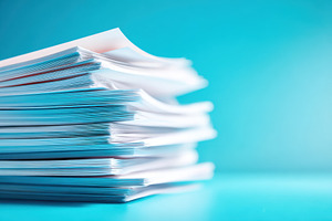 Stack of white documents on blue background, a Business Photo by AlyaAnd