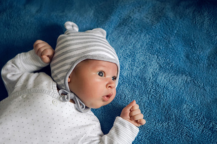 newborn lies in the hat, a Person Photo by SaulichPhoto