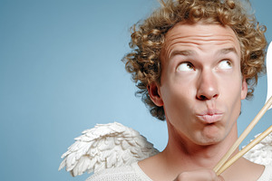 Playful young man dressed as a cupid, a Holiday Photo by MistyDay