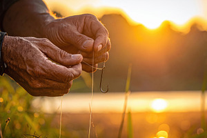 Angler Tying a Fishing Hook at Sunset, a Sports & Recreation Photo by Davizro's Market