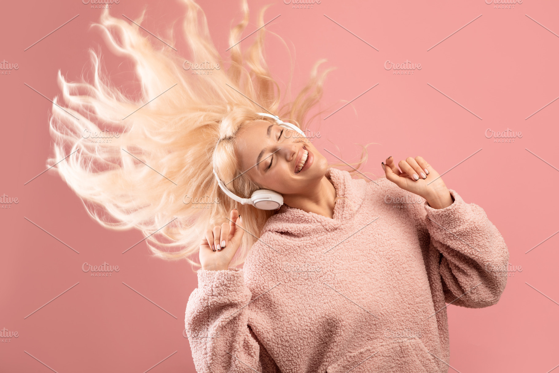 Enjoy the music concept. Joyful lady listening to music in headphones and danci, a Photo by Prostock-Studio