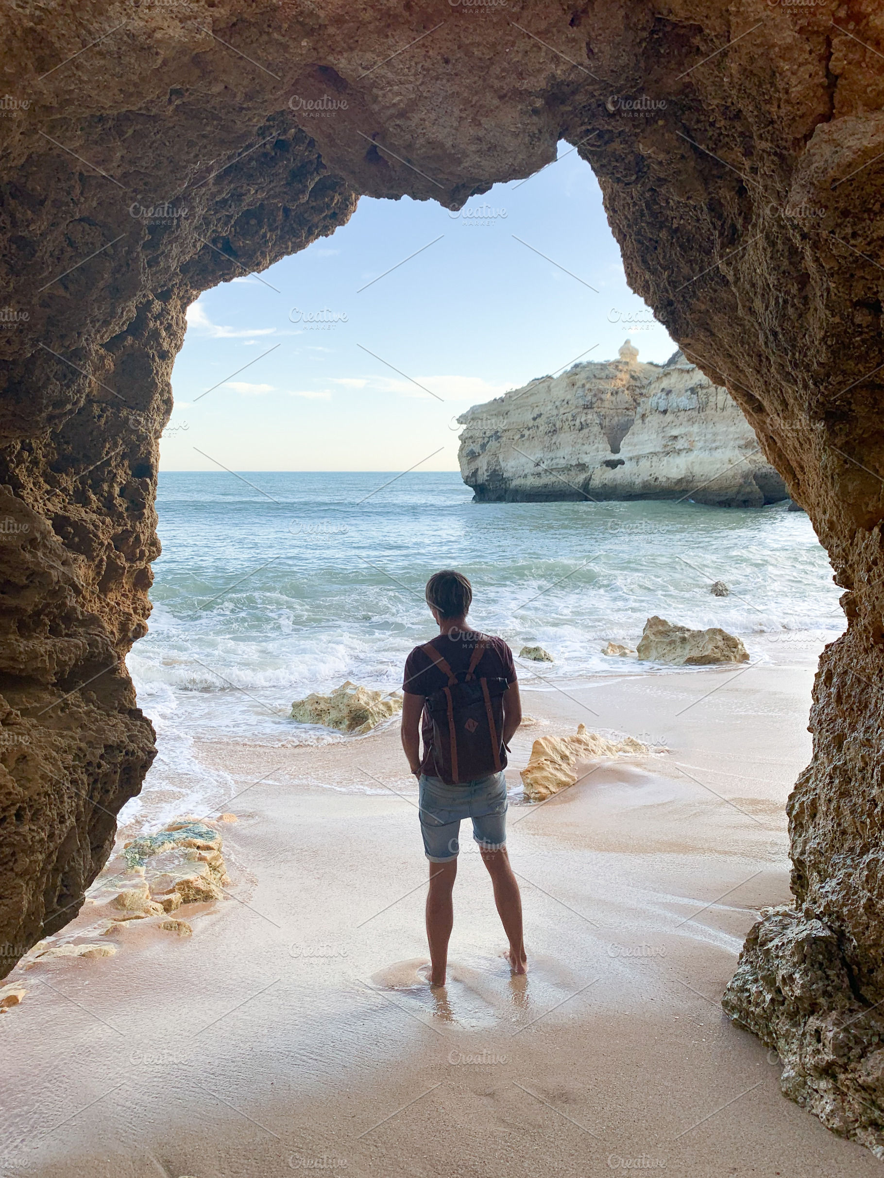A person stands barefoot on the sandy shore, admiring the coasta, a Holiday Photo by sebastianaraw