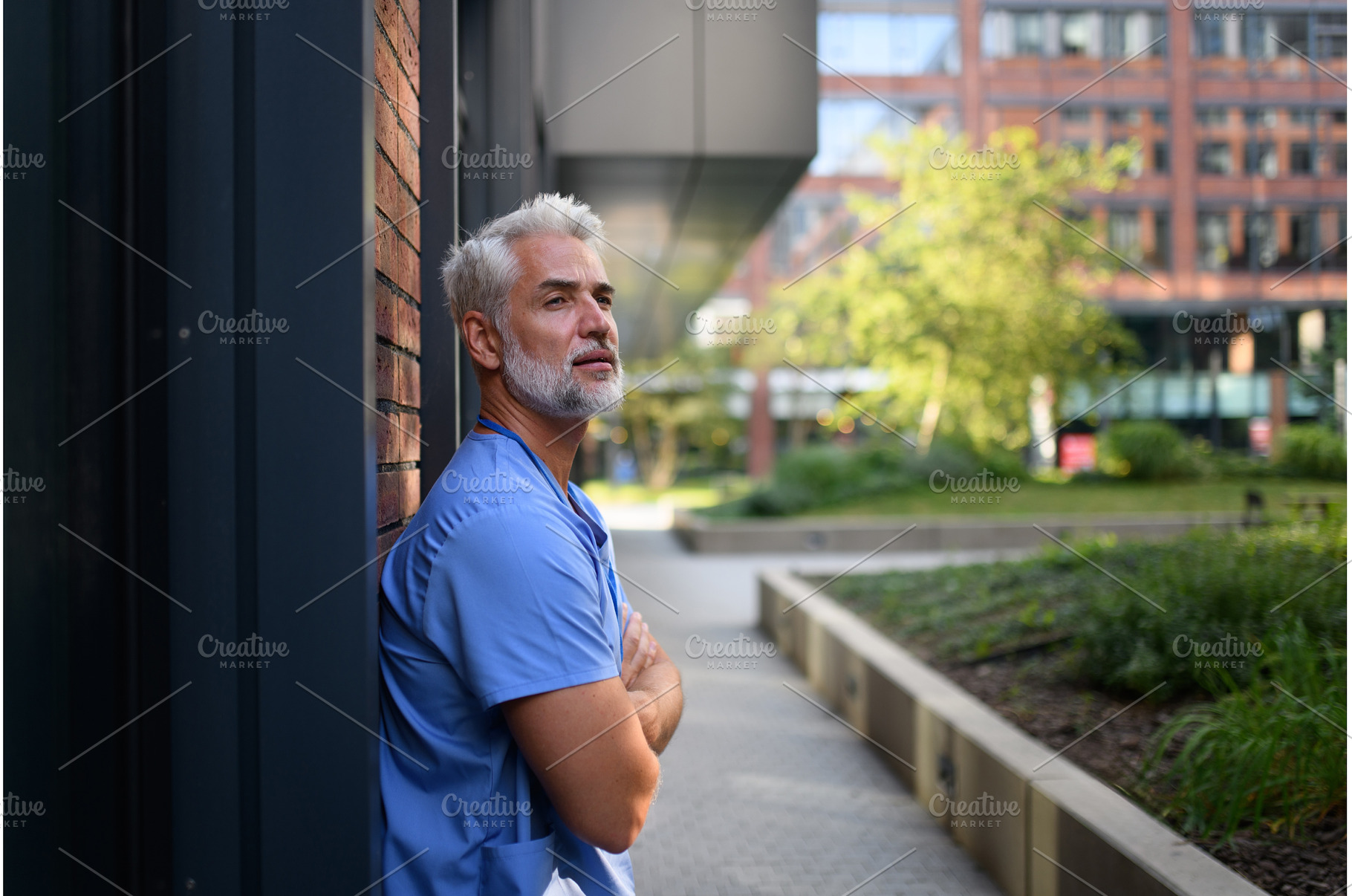 Healthcare worker outside hospital, a Health & Medical Photo by HalfPoint