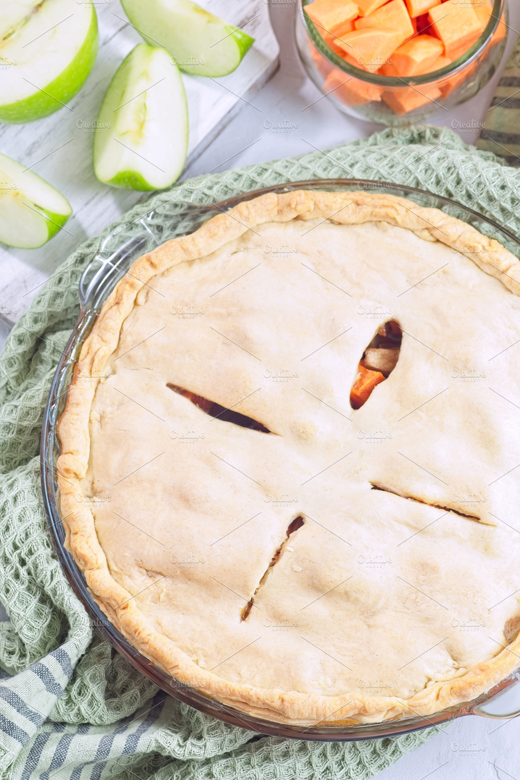 Sweet potato and apple cobbler in glass baking dish, vertical, top view, a Food & Drink Photo by iuliia_n
