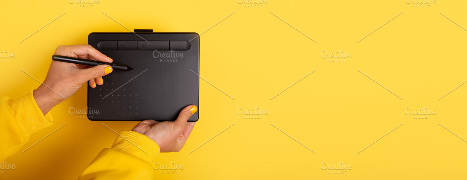 Person holding a digital drawing tablet and stylus against a bri, a Technology Photo by Ales Munt