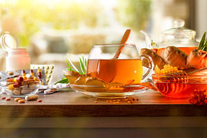 Natural medicine versus pharmaceuticals with infusion on wooden, a Food & Drink Photo by Davizro's Market