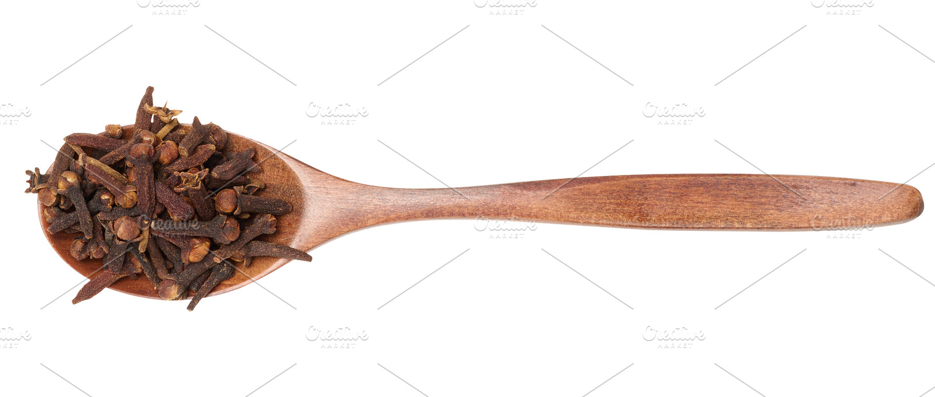 Whole dried clove buds in a dark wooden spoon, isolated on backg, a Food & Drink Photo by ndanko