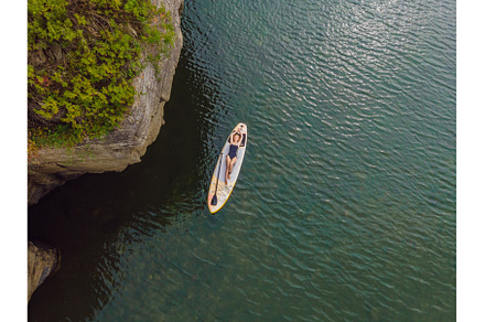 A woman lies on a sup, view from a, a Sports & Recreation Photo by Elizaveta Galitskaya