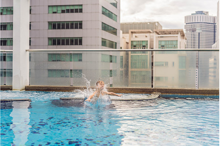 Boy jumping into the pool among the, an Architecture Photo by Elizaveta Galitskaya