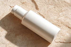 Bottle on stone surface in sunlight, a Photo by Beautiful things