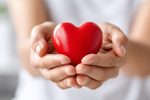 Woman holds a red heart in hand, a Health & Medical Photo by MistyDay